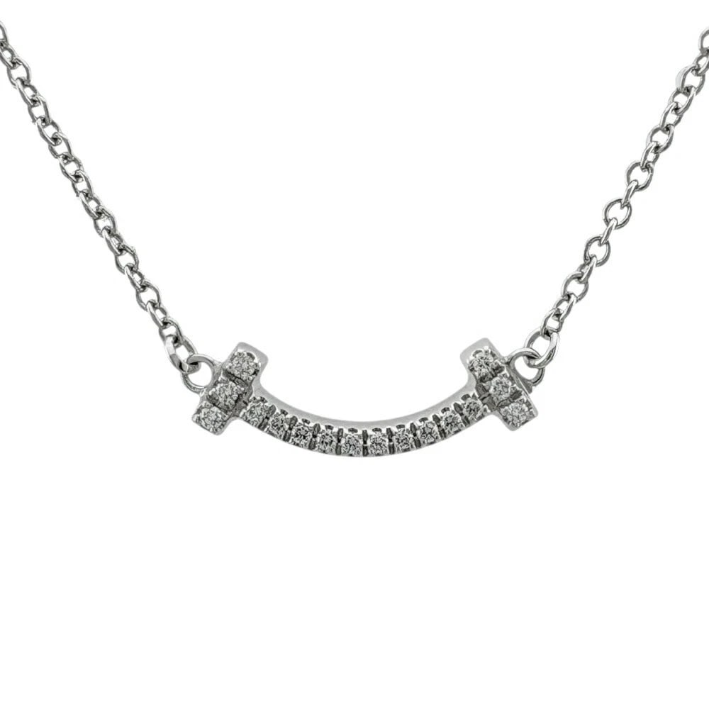 TIFFANY & CO. T SMILE DIAMOND NECKLACE 18K: Tiffany & Co. T Smile Diamond Necklace 18K Brand: Tiffany & Co. Type: Necklace Material: 18K White Gold (AU750) Main Stone/Creation Natural Color: White Size: Necklace Length: Approx. 18.1 in (46