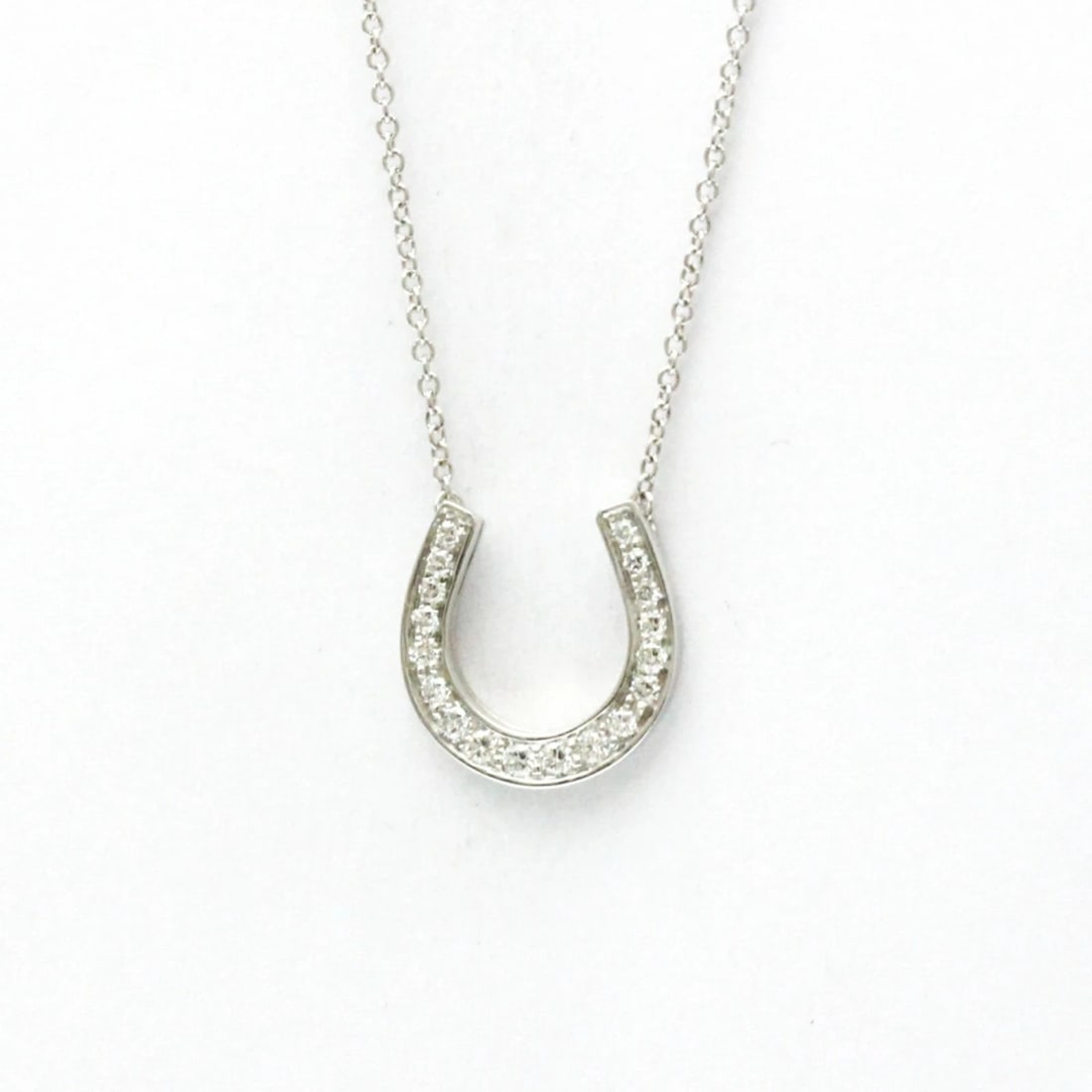 TIFFANY & CO. PLATINUM DIAMOND HORSESHOE PENDANT NECKLACE: Tiffany & Co. Platinum Diamond Horseshoe Pendant Necklace Brand: Tiffany & Co. Type: Necklace Material: Platinum (Pt950) Main Stone/Creation Natural Color: Silver Size: Chain Length: 15.94 in / 40