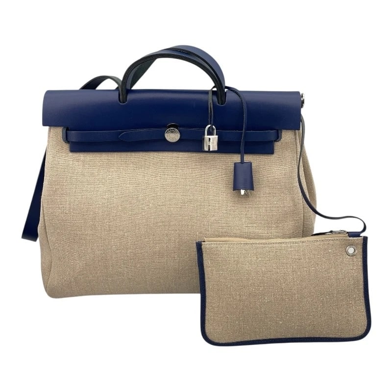 HERMES HERBAG ZIP MM HANDBAG: HERMES Herbag Zip MM Handbag Brand: HERMES Type: Handbag Material: Toile Hunter Color: Blue Saphir SVHardware Size: W15.2 x H12.6x D5.5inch Accessories: None Accessories Notice: When
