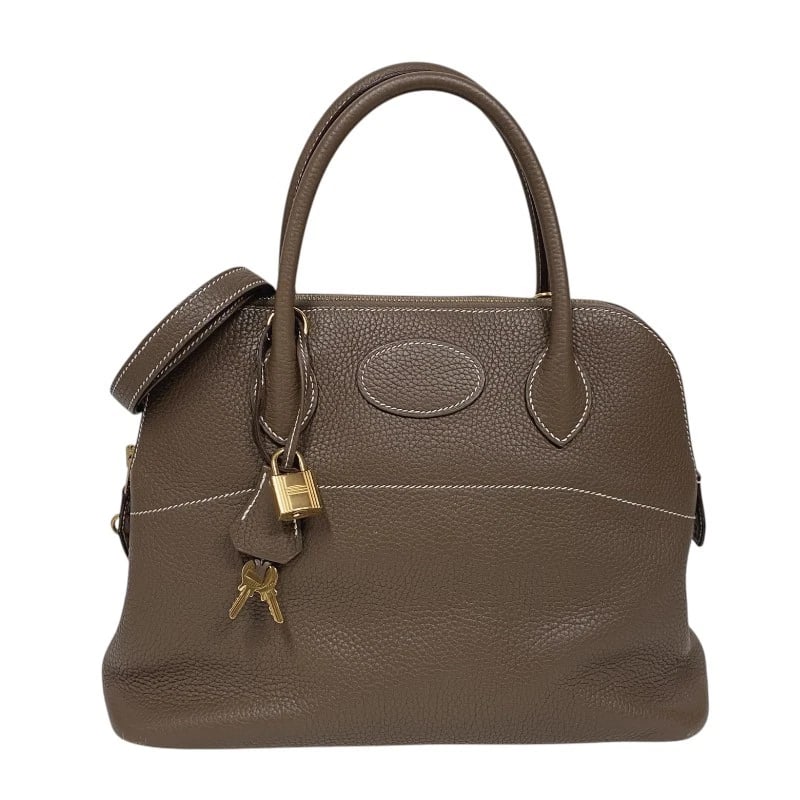 HERMES BORED 31 HANDBAG: HERMES Bored 31 Handbag Brand: HERMES Type: Handbag Material: Taurillon Clemence Color: Etup Gold Hardware Size: W12.2 x H9.1x D4.7inch Accessories: None Accessories Notice: When purchasing pre-owned