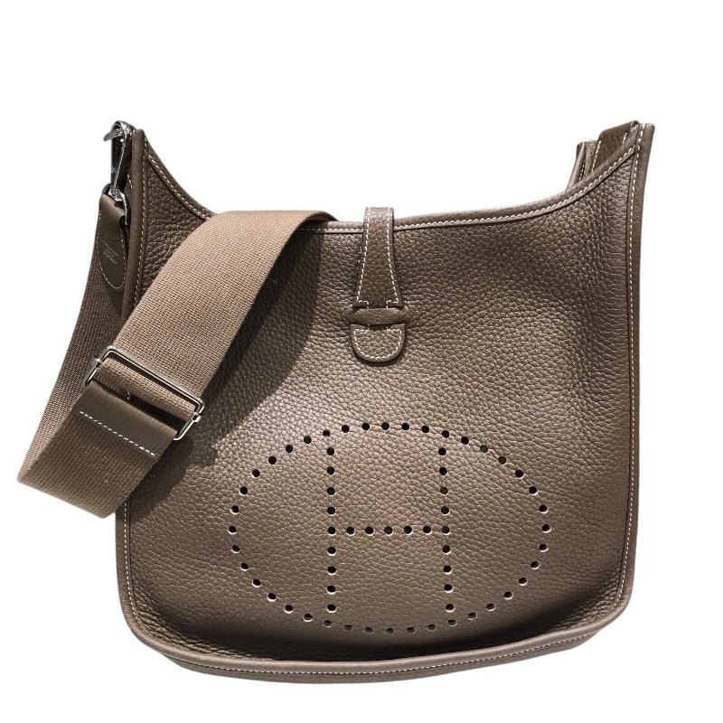 HERMES EVELYNE3PM TAURILLON SHOULDER BAG: HERMES Evelyne3PM Taurillon Shoulder Bag Brand: HERMES Type: Handbag Material: Taurillon Color: Etoupe SV Hardware Size: W: 29cm / H: 27cm / D: 5cm Accessories: None Accessories Notice: Wh