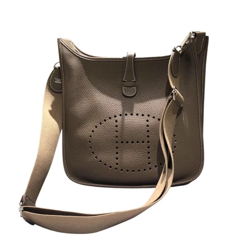 HERMES EVELYNE SHW TAURILLON SHOULDER BAG: HERMES Evelyne SHW Taurillon Shoulder Bag Brand: HERMES Type: Handbag Material: Taurillon Color: Etoupe / SV Hardware Size: W: 29cm / H: 31cm / D: 6cm Accessories: None Accessories Notice: