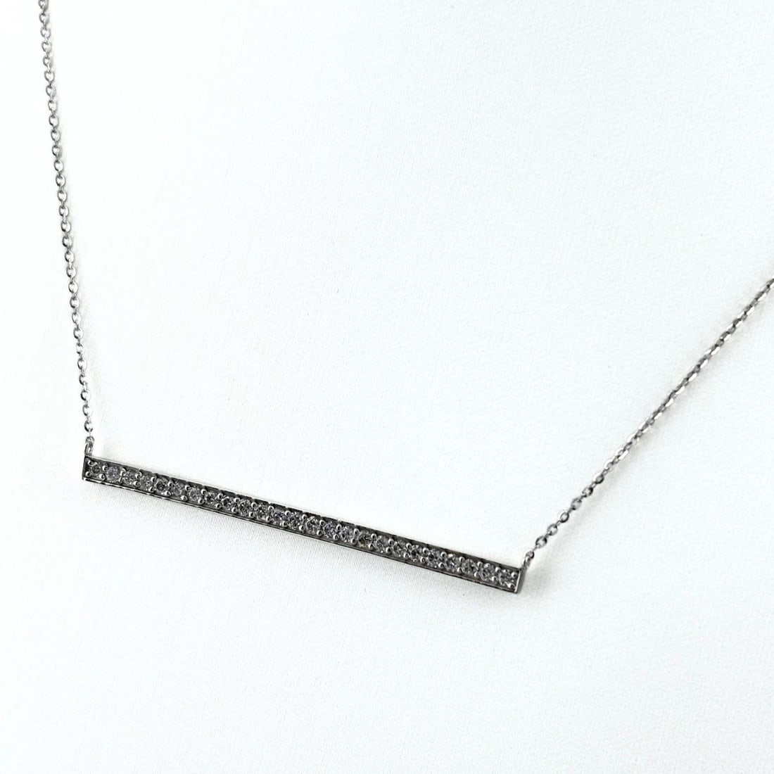 MELEE DIAMOND DESIGN NECKLACE: Melee Diamond Design Necklace Brand: Unbranded Type: Necklace Material: K10, Color: WhiteGold Size: Chain / code 86.5cm(34.1") Pendant size 2.8×48.2mm(0.1") Accessories: None Accessories Notice: