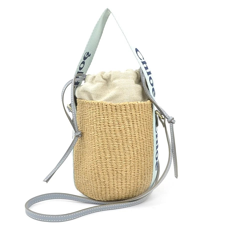 CHLOE WOODY SMALL BASKET SHOULDER BAG: Chloe Woody Small Basket Shoulder Bag Brand: Chloe Type: Shoulder Bag Material: Raffia Color: Green X Natural Size: W:5.5inx H:8.7inx D:5.5in Handle Length:15.7in Accessories: None Accesso