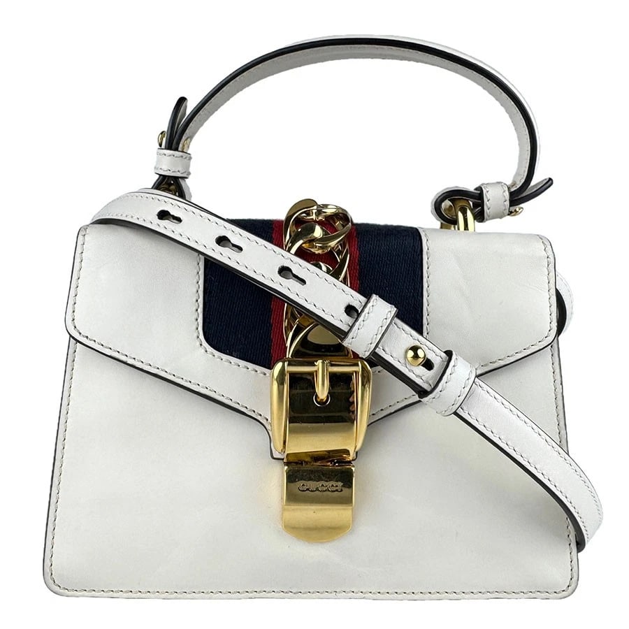 GUCCI SYLVIE HANDBAG SHOULDER BAG LEATHER/METAL: GUCCI Sylvie Handbag Shoulder Bag Leather/Metal Brand: GUCCI Type: Shoulder Bag Material: Leather Color: White / Navy / Red Size: W:7.1inx H:5.5inx D:3.1in Handle Length:10.6in Accessories: None <