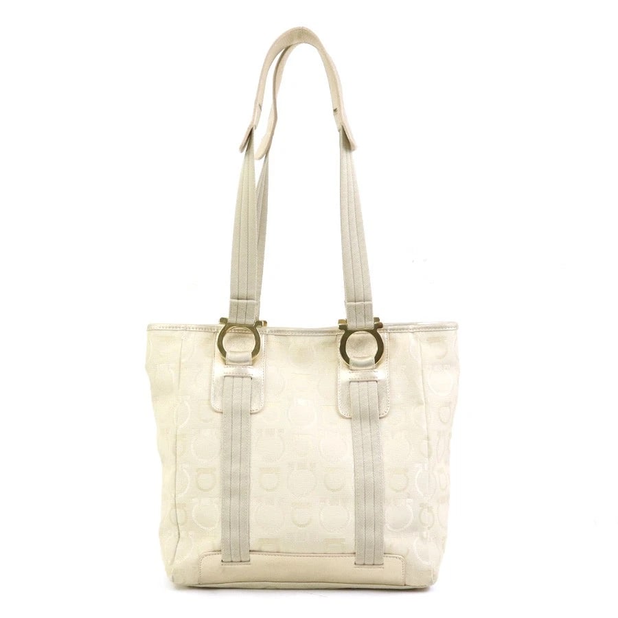 SALVATORE FERRAGAMO GANCINI SHOULDER BAG: Salvatore Ferragamo Gancini Shoulder Bag Brand: Salvatore Ferragamo Type: Shoulder Bag Material: Canvas/Leather Color: Light Beige/Gold Size: W:9.4inx H:10.0inx D:4.3in Accessories: None A