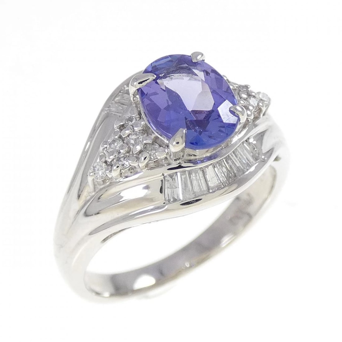 PT900 TANZANITE RING: PT900 Tanzanite Ring Brand: Unbranded Type: Tanzanite Ring Material: PT900, Main Stone/Creation TanzaniteSecondary Stone Diamond Color: silver Size: US7 1/4 Accessories: None Accessories Notice: When