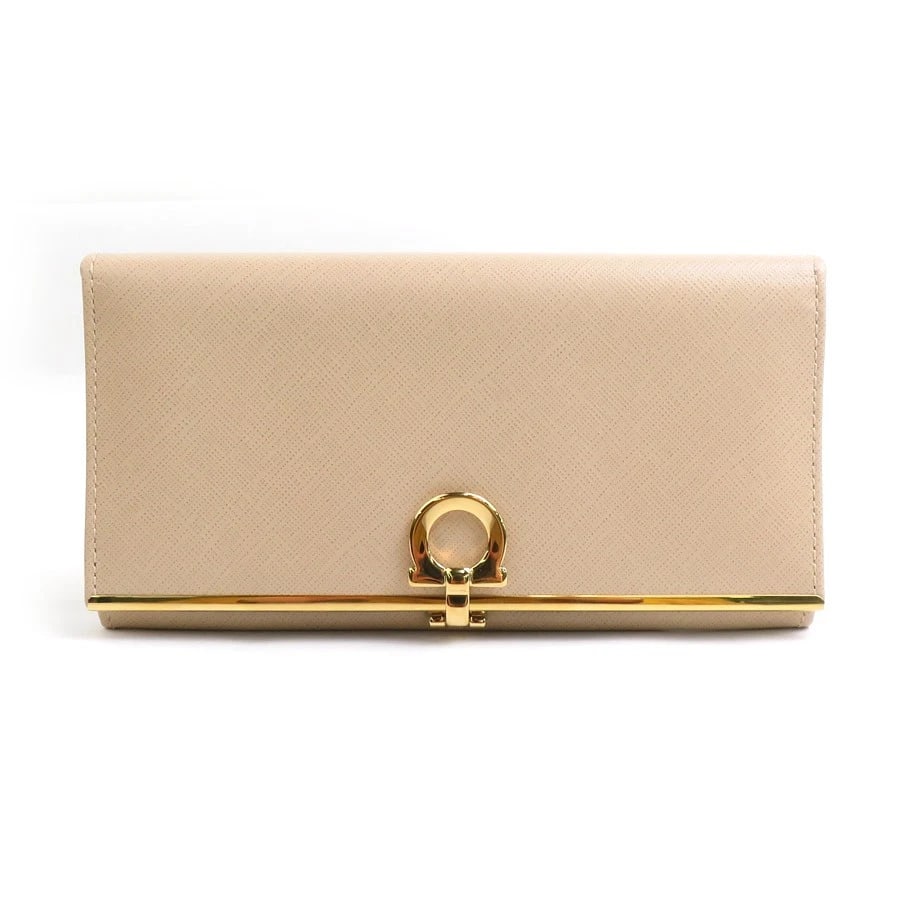 SALVATORE FERRAGAMO GANCINI BIFOLD LONG WALLET: Salvatore Ferragamo Gancini Bifold Long Wallet Brand: Salvatore Ferragamo Type: Bifold Long Wallet Material: Leather Color: Beige Size: W:7.5inx H:3.7inx D:0.8in Accessories: None Accessor