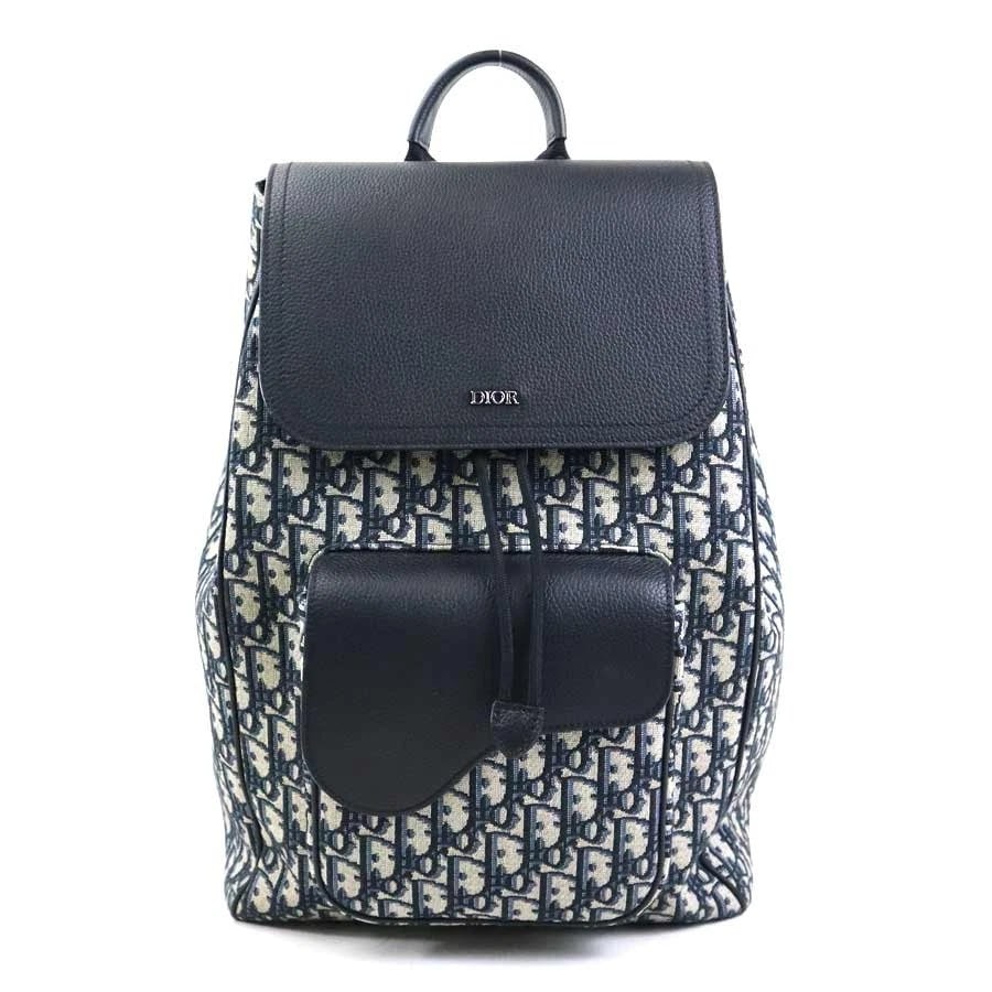CHRISTIAN DIOR OBLIQUE BACKPACK CANVAS/LEATHER: Christian Dior Oblique Backpack Canvas/Leather Brand: Christian Dior Type: Backpack Material: Canvas/Leather Color: Navy Size: W:10.2inx H:15.7inx D:5.1in Handle Length:7.5in Accessories: None