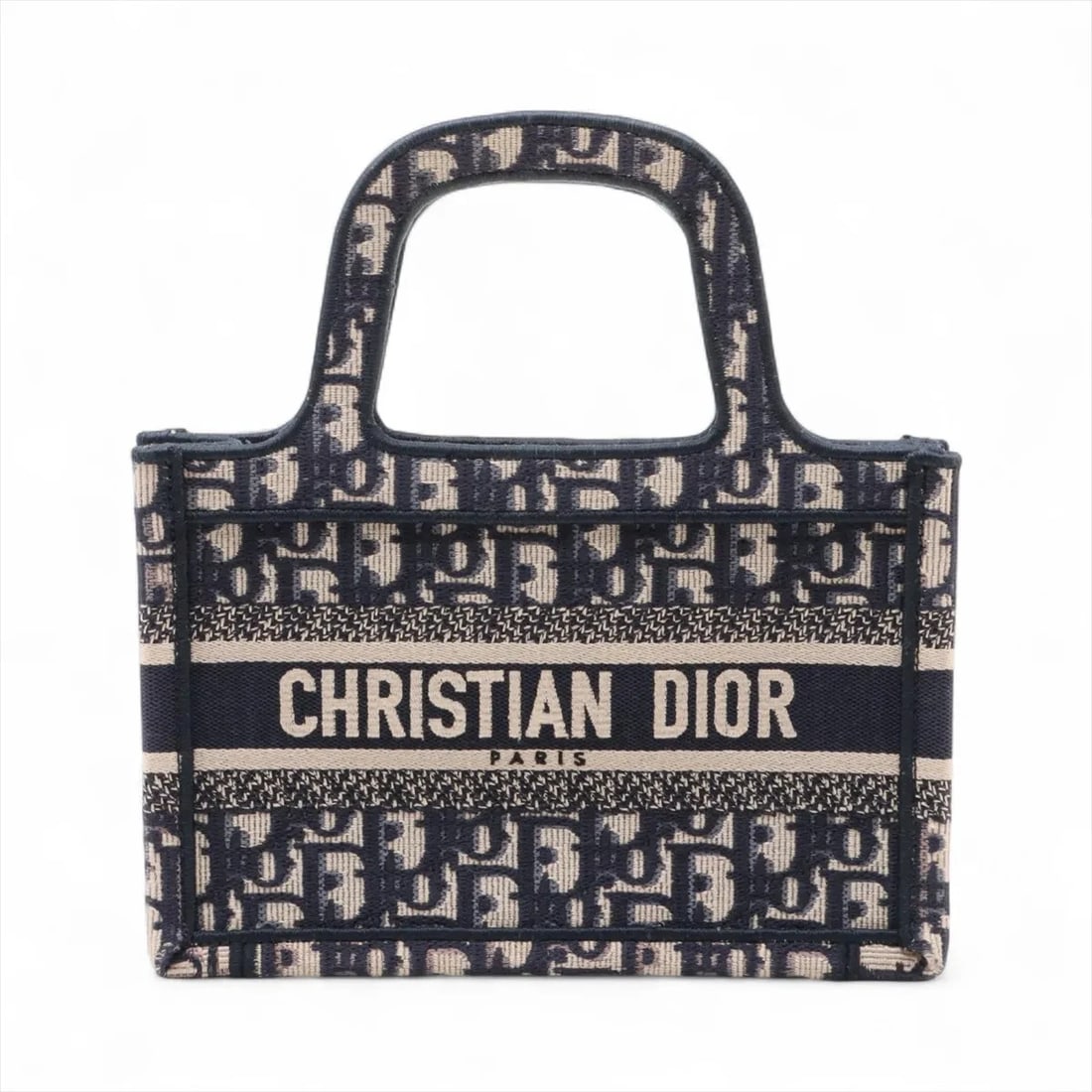 CHRISTIAN DIOR OBLIQUE MINI BOOK TOTE CANVAS HAND BAG: Christian Dior Oblique Mini book tote canvas Hand bag Brand: Christian Dior Type: Hand bag Material: canvas Color: Navy Blue Size: Height:5.9inch Length:8.9inch Depth:2.4inch Handle height:3.0inch