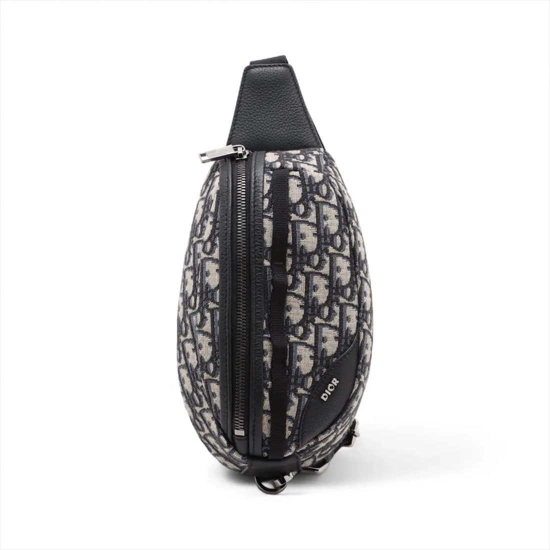 DIOR OBLIQUE CANVAS X LEATHER SLING BACKPACK: Dior Oblique canvas x leather Sling backpack Brand: Dior Type: Waist pouch/Crossbody bag Material: Canvas & Leather Color: Navy Blue Size: Height:8.7inchLength:4.7inchDepth:2.4inch Accessories: No