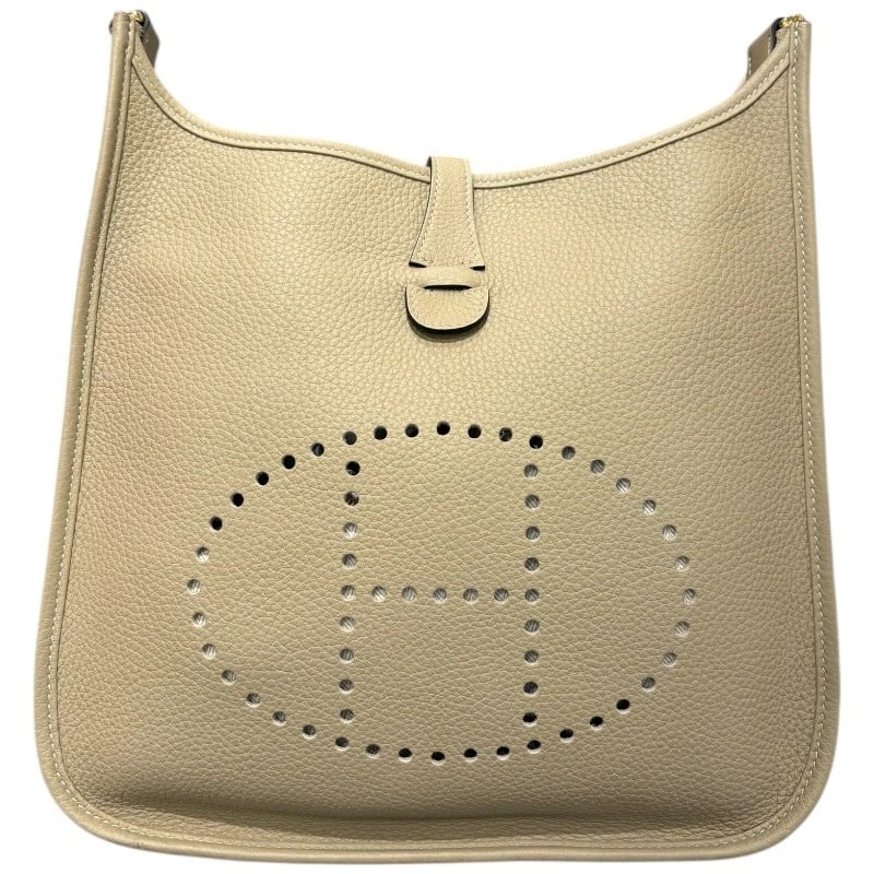 HERMES EVELYN 3 PM SHOULDER BAG: HERMES Evelyn 3 PM Shoulder Bag Brand: HERMES Type: Shoulder Bag Material: Taurillon Clemence Color: Trench Gold Hardware Size: W29cm x H30.5cmx D7cmW11.4 x H12.0x D2.8inch Accessories: None <