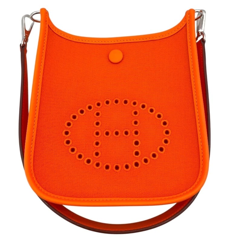 HERMES NEO EVELYN TPM SHOULDER BAG: HERMES Neo Evelyn TPM Shoulder Bag Brand: HERMES Type: Shoulder Bag Material: Towar Color: Orange SVHardware Size: W17cm x H18cmx D5cm W6.7 x H7.1x D2.0inch Accessories: None Accessories N