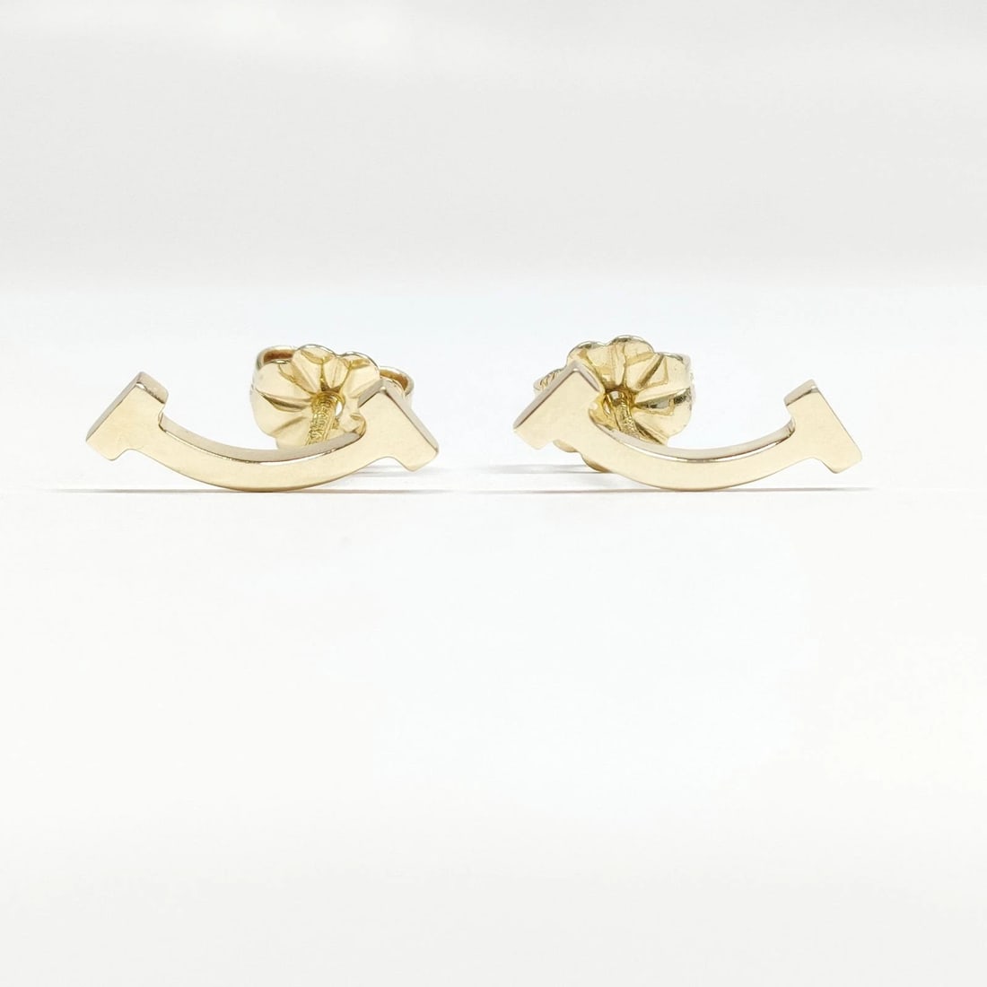 TIFFANY AND CO. PIERCED EARRING T SMILE GOLD: Tiffany and Co. Pierced Earring T smile Gold Brand: Tiffany and Co. Type: Pierced Earring Material: Gold, Color: Yellow Gold Size: None Accessories: None Accessories Notice: When purchasin