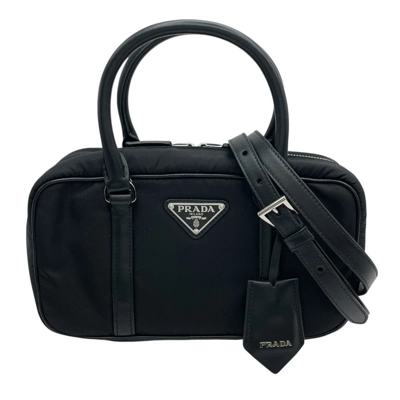 PRADA RE-NYLON 2-WAY HANDBAG HANDBAG: PRADA Re-Nylon 2-way handbag Handbag Brand: PRADA Type: Handbag Material: Nylon Color: black Size: W24cm x H13cmx D9cm W9.4 x H5.1x D3.5inch Accessories: None Accessories Notice: When purchasing