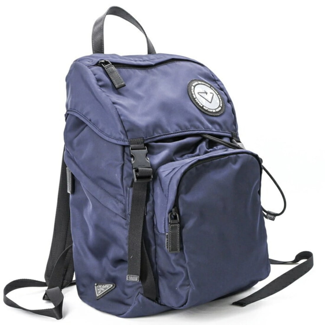 PRADA RE-NYLON BACKPACK IN NAVY WITH SAFFIANO LEATHER: PRADA Re-Nylon Backpack in Navy with Saffiano Leather Brand: Prada Type/Style: Backpack Material: Nylon Color: Navy Size: (HxWxD) 45cm x 26cm x 16cm / 17.71'' x 10.23'' x 6.29'' Accessories: None