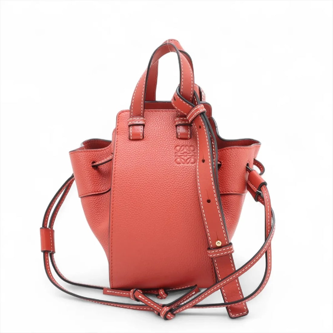 LOEWE HAMMOCK DRAWSTRING MINI LEATHER 2 WAY HANDBAG HANDBAG: Loewe Hammock Drawstring Mini Leather 2 Way Handbag Handbag Brand: Loewe Type/Style: Hand bag Material: Leather Color: Orange Size: Height:7.3inch Length:4.1inch Depth:6.5inch Handle height:2.4inch