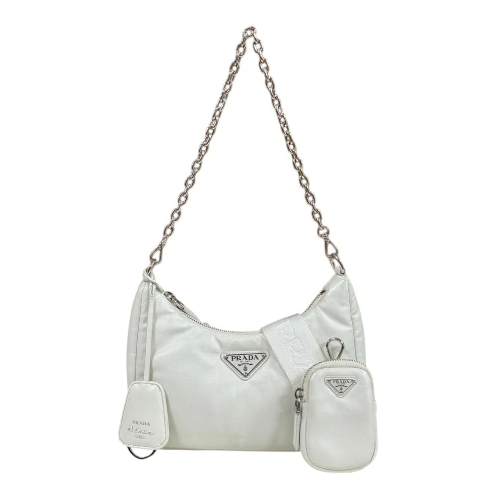 PRADA RE-EDITION 2005 SHOULDER BAG CROSS BODY: PRADA Re-Edition 2005 Shoulder Bag Cross Body Brand: PRADA Type/Style: Shoulder Bag Material: Exterior Material leather Color: Exterior Color white Size: W8.9 x H6.3 x D3.0inch Handle:18.5inch Acc