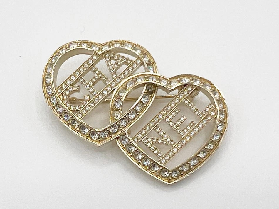 CHANEL DOUBLE HEART CRYSTAL BROOCH GOLD: Chanel Double Heart Crystal Brooch Gold Brand: Chanel Type/Style: Brooch Material: Crystal, metal, Color: Champagne gold Size: W1.8 inches x H1.4 inches Accessories: None Accessories Notice: When