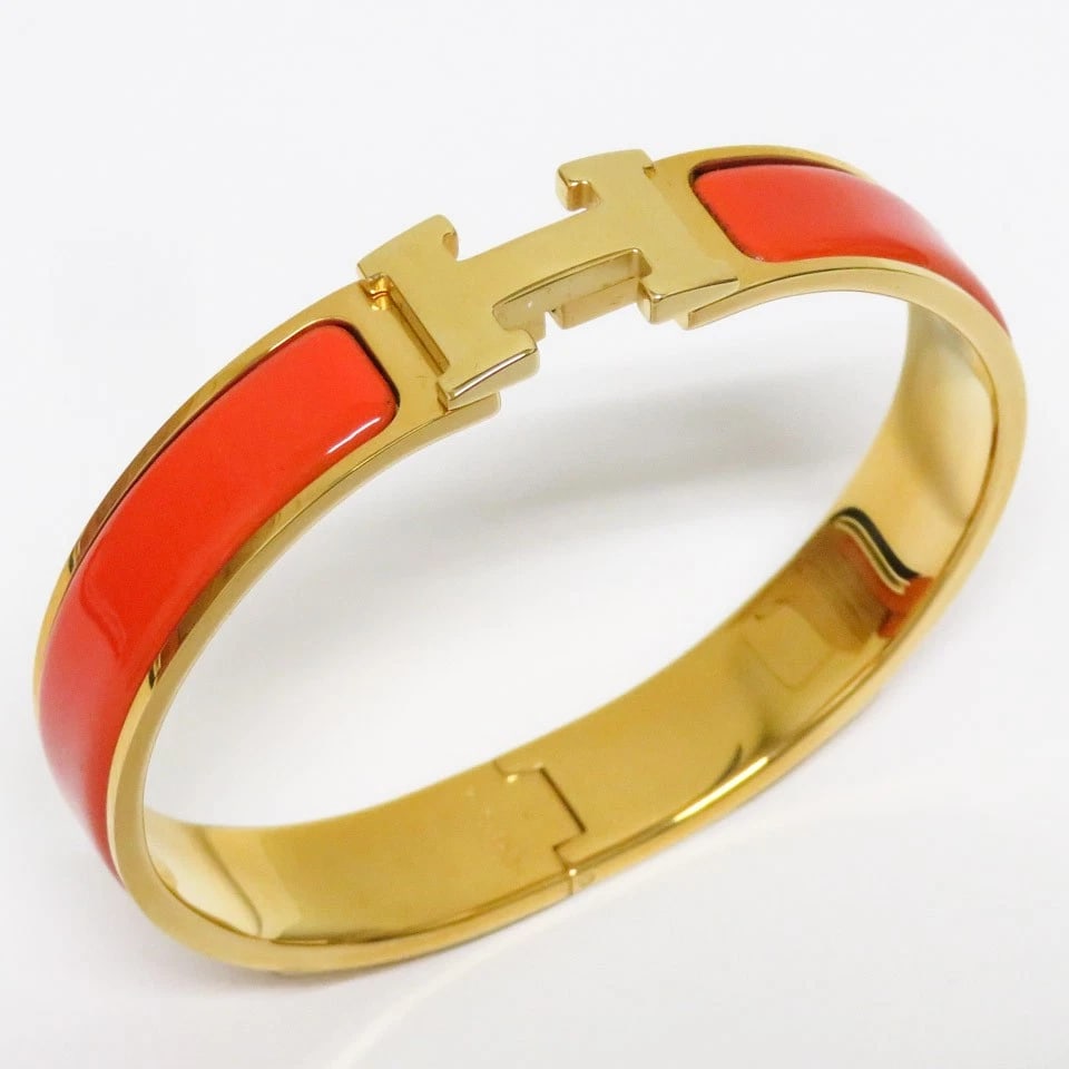 HERMES BRACELET GOLD & ORANGE: Hermes Bracelet Gold & Orange Brand: Hermes Type/Style: Bangle, Bracelet Material: Metal, Enamel, Color: Gold, Orange Size: Width: 0.5 in, Inner Diameter: 2.3 in, Total Length: 7.1 in Accessories: