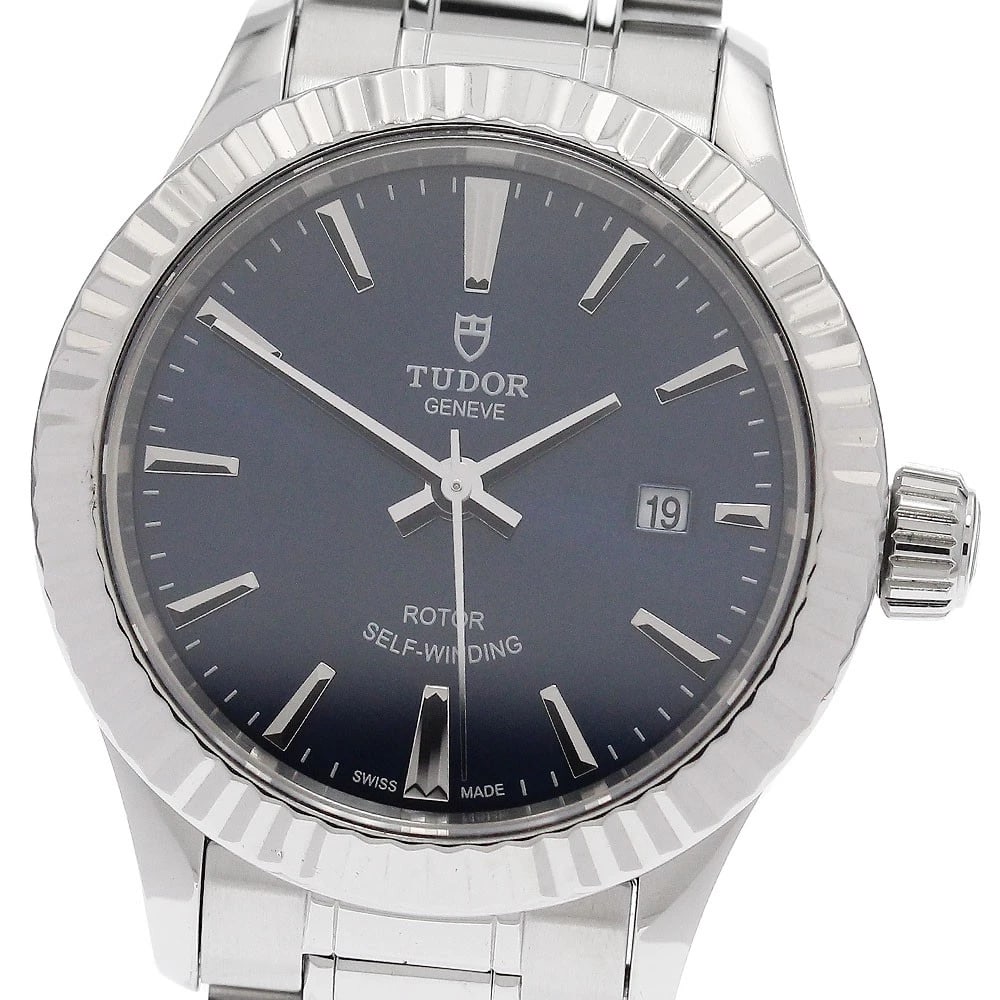 TUDOR STYLE DATE LADIES WATCH: TUDOR Style Date Ladies Watch Brand: TUDOR Type/Style: Wristwatch Material: Band Material Stainless Steel, Case Material Stainless Steel Color: Band Color Silver, Dial Color Navy, Case Color Silver Si