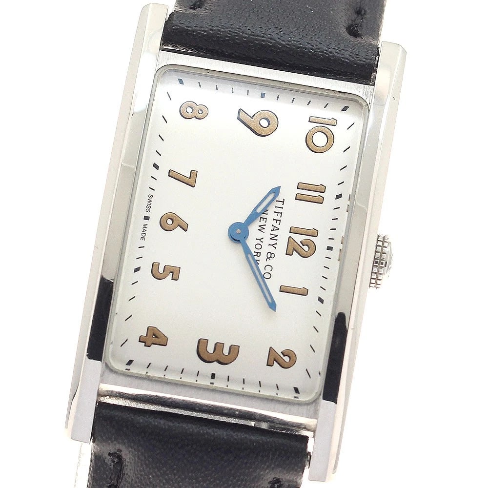 TIFFANY EAST WEST MINI QUARTZ LADIES WATCH: TIFFANY East West Mini Quartz Ladies Watch Brand: TIFFANY&Co. Type/Style: Wristwatch Material: Band Material leather, Case Material Stainless Steel Color: Band Color black, Dial Color Silver, Case Col