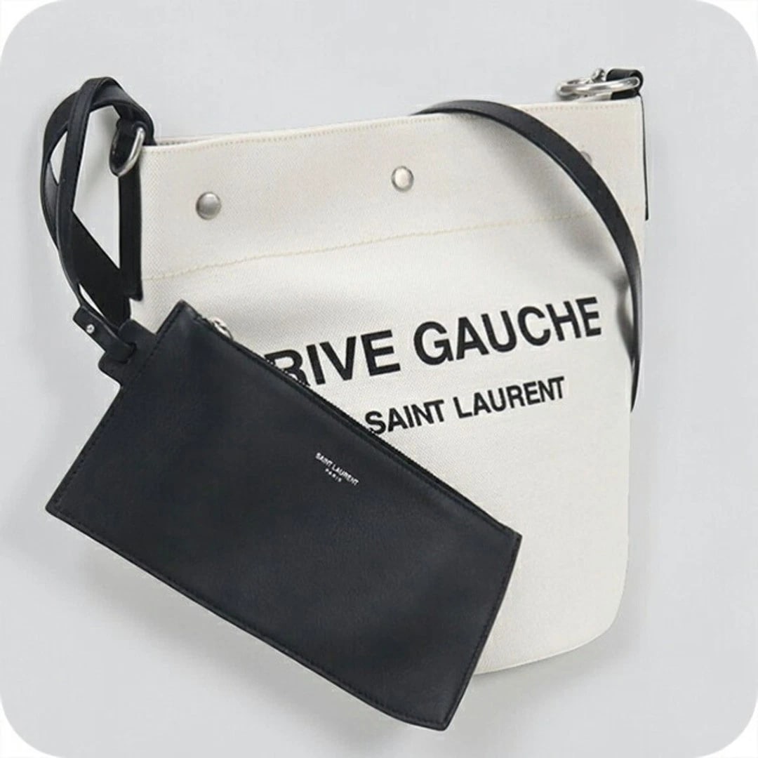 SAINT LAURENT RIVE GAUCHE BUCKET BAG CANVAS: Saint Laurent Rive Gauche Bucket Bag Canvas Brand: SAINT LAURENT Type/Style: Bag Material: Canvas Color: White Size: Height: 20 cm (7.9 in) Width: 20 cm (7.9 in) Depth: 10 cm (3.9 in) Accessories: