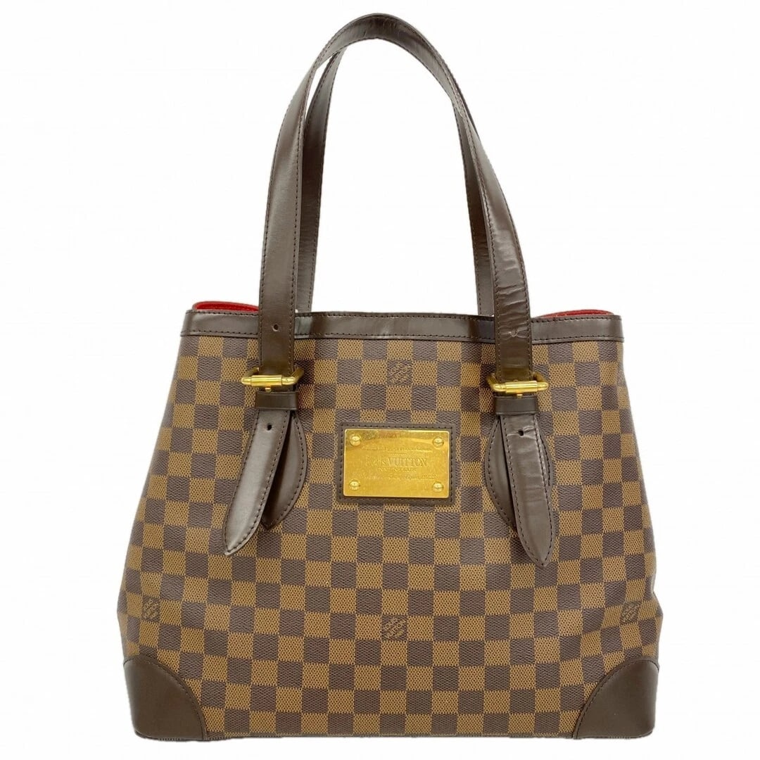 LOUIS VUITTON DAMIER HAMPSTEAD MM TOTE BAG: Louis Vuitton Damier Hampstead MM Tote Bag Brand: LOUIS VUITTON Type/Style: Tote Bag Material: Exterior Material Canvas Color: Ebenu Size: 28.5 cm (11.2 in) H x 35 cm (13.8 in) W x 17 cm (6.7 in) D