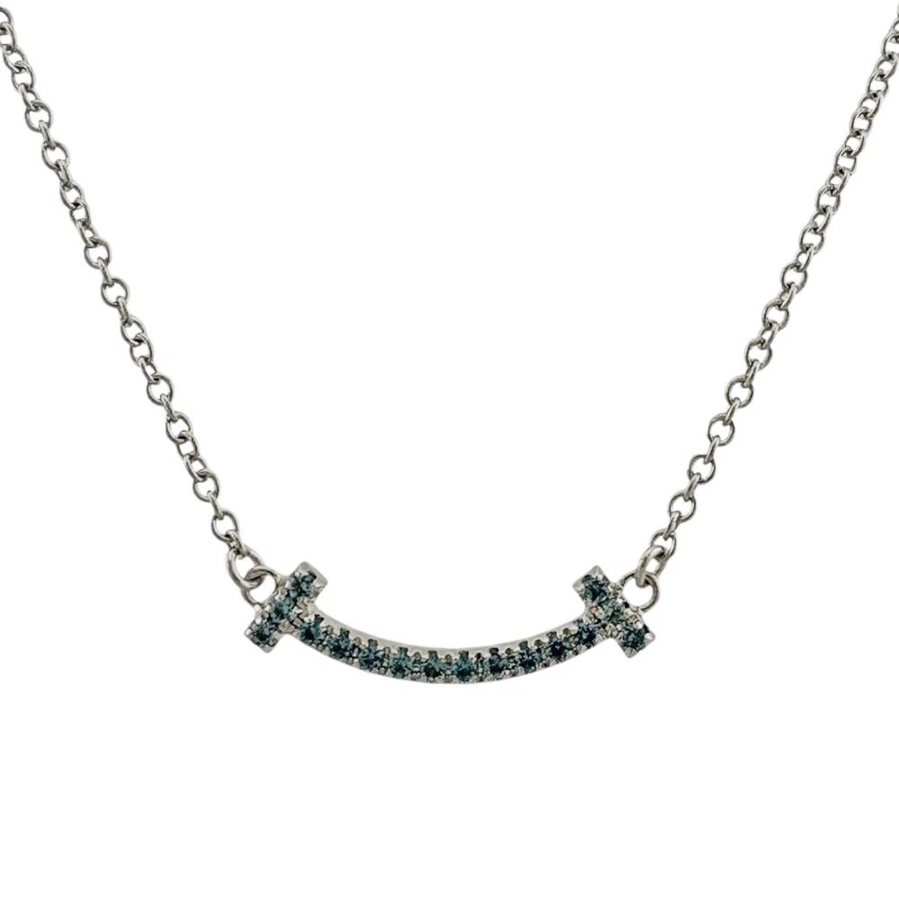 TIFFANY & CO. T SMILE BLUE TOPAZ NECKLACE: Tiffany & Co. T Smile Blue Topaz Necklace Brand: Tiffany & Co. Type/Style: Necklace Material: 18K White Gold, Main Stone/Creation Blue Topaz Color: WG Size: Size: Chain Length approx. 46 cm (18
