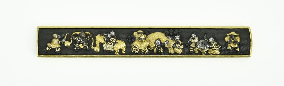 KINKO KODZUKA: Kinko Kodzuka Size: Description: Kinko Kodzuka. Motif of Chinese boys engaging in dance with accompanying music. Gold, silver and Shakudo highlights. Shakudo Nanako ground. Reverse has gold