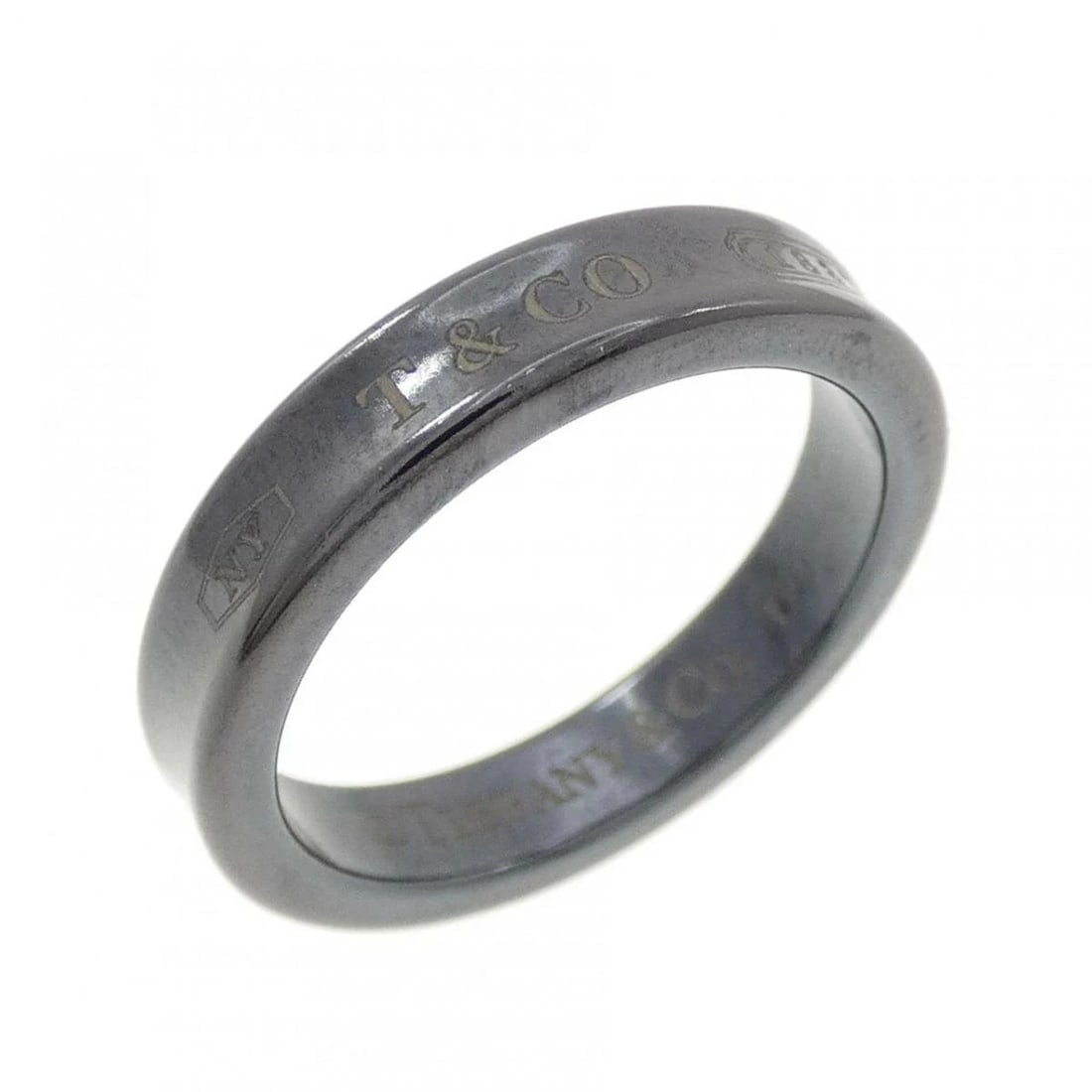 TIFFANY NARROW TITANIUM RING: Tiffany Narrow Titanium Ring Brand: Tiffany & Co. Type/Style: Ring Material: Titanium, Color: None Size: US 6.25 Accessories: None Accessories Notice: When purchasing pre-owned goods, plea