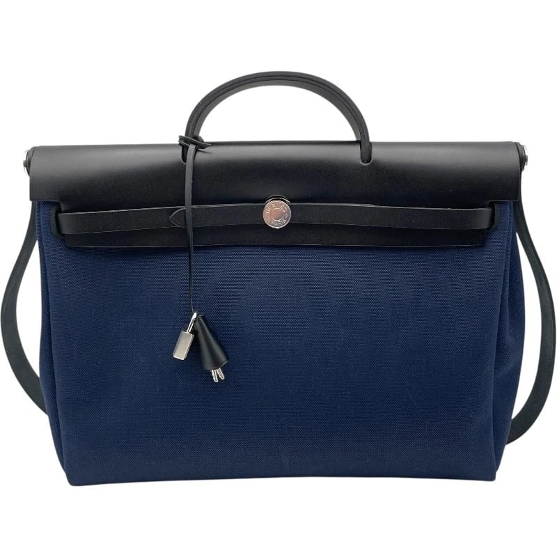 HERMES HERBAG ZIP MM HANDBAG: HERMES Herbag Zip MM Handbag Brand: HERMES Type/Style: Handbag Material: Toile Vache Hunter Color: Navy SV Hardware Size: W15.2 x H12.6 x D5.5inch Accessories: None Accessories Notice: Whe