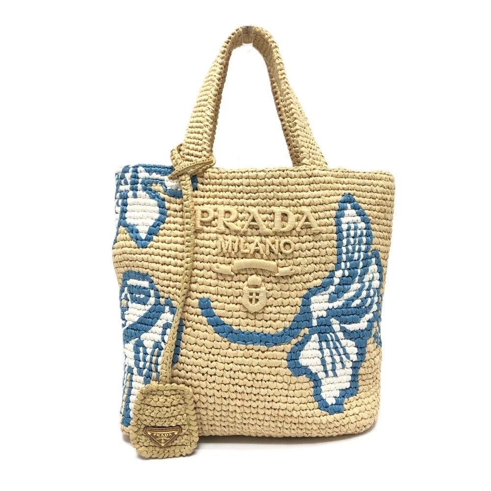 PRADA LOGO ST. BARTHS ISLAND EXCLUSIVE SMALL BAG HANDBAG: PRADA Logo St. Barths Island Exclusive Small bag Handbag Brand: PRADA Type/Style: Hand Bag Material: Raffia Color: Beige / GoldHardware Size: W8.7?H9.4?D3.9inch / W22cm H24cm D10cm Handle: 11.8inch / 