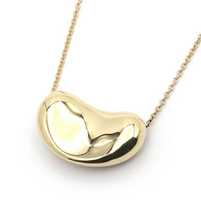 TIFFANY & CO. BEAN DESIGN PENDANT BEANS NECKLACE: Tiffany & Co. Bean Design Pendant Beans Necklace Brand: Tiffany & Co. Type/Style: Pendant Material: 18K YG Color: YG Size: Size Effective length 40cm Chain width 1.0mm Motif 20.4mm x 12.7mm Access