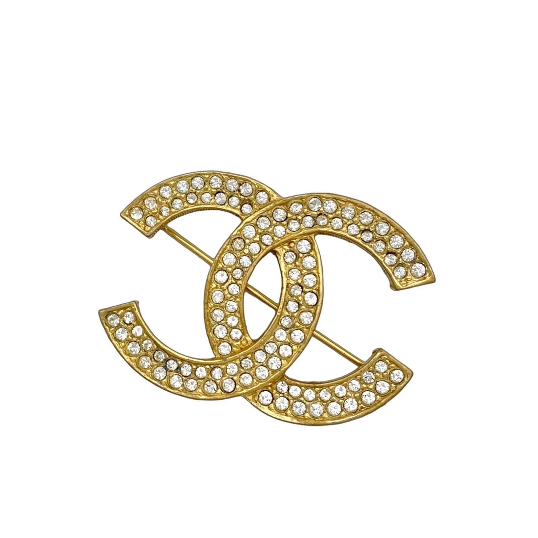 CHANEL GOLD BROOCH WITH DOUBLE ROW RHINESTONES LOGO: Chanel Gold Brooch with Double Row Rhinestones Logo Brand: CHANEL Type/Style: Brooch Material: Gold plating Rhinestones Color: Gold Size: approximately 1.7 in x 1.2 in Accessories: None Ac