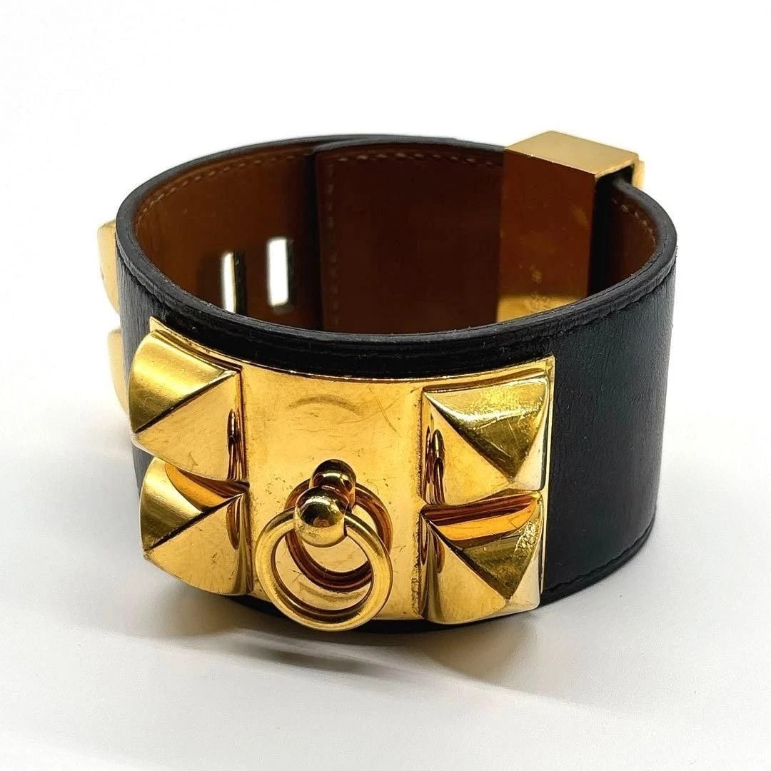 HERMES CORYEDOSIAN BLACK LEATHER GOLD BRACELET: Hermes Coryedosian Black Leather Gold Bracelet Brand: Hermes Type/Style: Bracelet Material: Leather Metal Color: Black, Gold Size: Length 8.3 in, Width 1.6 in, Wrist 5.5-6.1 in (adjustable) Access