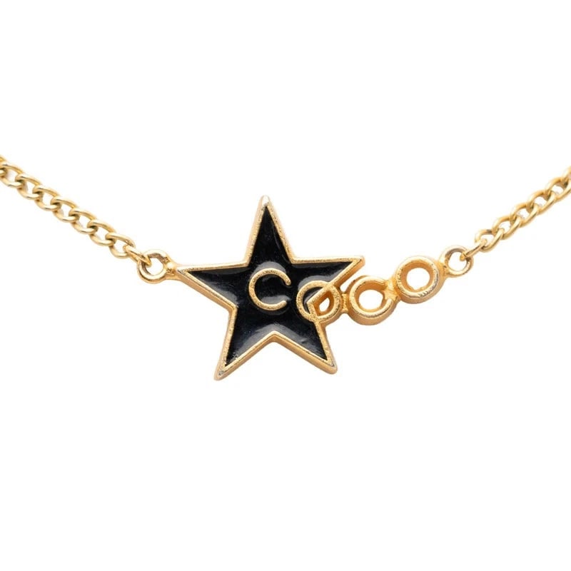 CHANEL STAR NECKLACE GOLD & BLACK ENAMEL: CHANEL Star Necklace Gold & Black Enamel Brand: CHANEL Type/Style: Necklace Material: Plated Enamel Color: Gold, Black Size: Top W approximately 1.2 in x H approximately 0.6 in Accessories: None <