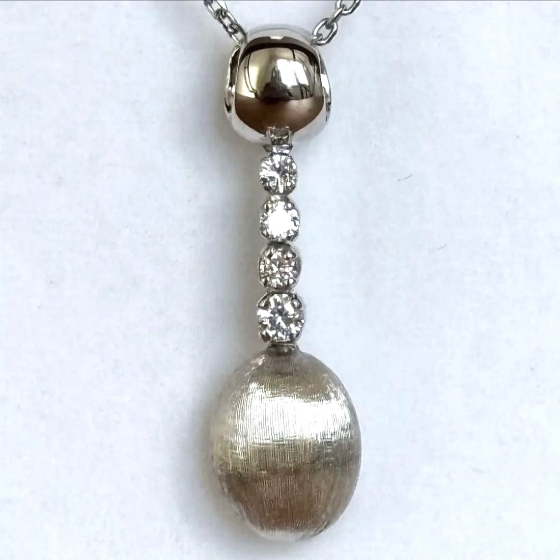NANIS ITALY DIAMOND 18K WHITE GOLD DROP SWING PENDANT: Nanis Italy Diamond 18k White Gold Drop Swing Pendant Brand: Nanis Type/Style: Pendant Material: 18k White Gold, Main Stone Natural Color: White Size: Pendant Length: Approx. 2.8 cm / 1.1 in Bail Size