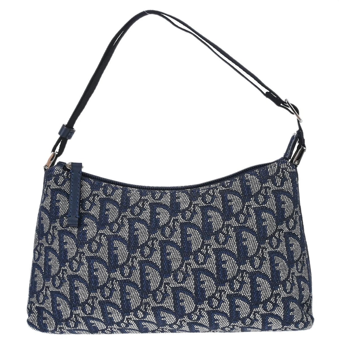 CHRISTIAN DIOR NAVY TROTTER HANDBAG: Christian Dior Navy Trotter Handbag Brand: Dior Type/Style: Saddle Bag Material: Canvas, Leather Color: Navy Size: W 9.8 x H 5.9 x D 2.4 " Accessories: None Accessories Notice: When purcha