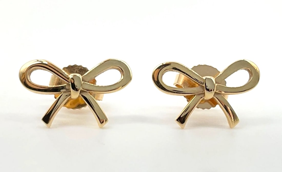 TIFFANY & CO BOW RIBBON STUD PIERCED EARRINGS: Tiffany & Co Bow Ribbon Stud Pierced Earrings Brand: Tiffany & Co. Type/Style: Earrings Material: 18k Yellow Gold Color: Yellow Size: H 8.5 mm ? W 13.5 mm ? D 10 mm / 0.3 in ? 0.5 in ? 0.4 in Acce