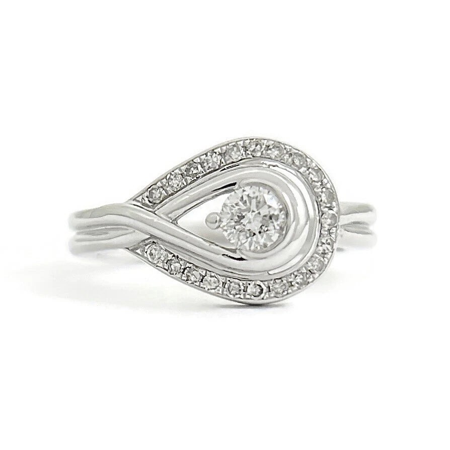 ASYMMETRICAL DIAMOND LOOP OPEN EYE HALO RING 10K WHITE GOLD: Asymmetrical Diamond Loop Open Eye Halo Ring 10K White Gold Brand: Estate Type/Style: Ring Material: 10K White Gold, Main Stone Natural Color: Silver Size: 6.5 US Accessories: None Accessories