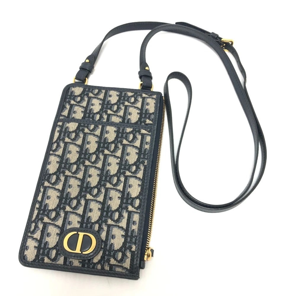 DIOR OF LEAGUE PHONE CASE WALLET CROSSBODY SHOULDER BAG: Dior Of League Phone Case Wallet Crossbody Shoulder Bag Brand: Dior Type/Style: Shoulder Bag Material: Canvas Color: Navy / GoldHardware Size: W4.5 H7.9 D0.2inch / W11.5cm H20cm D0.5cm Accessories