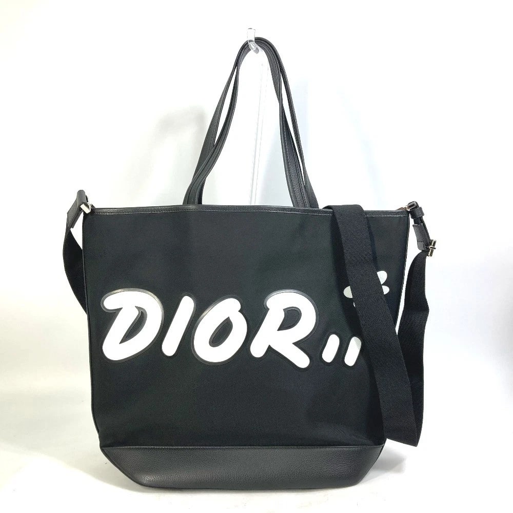 DIOR HOMME KAWS COLLAB JAPAN LIMITED CROSSBODY TOTE BAG: DIOR HOMME KAWS collab Japan limited Crossbody Tote Bag Brand: DIOR HOMME Type/Style: Tote Bag Material: Nylon / Leather Color: BlackxPink x White Size: W16.5?H13.0?D5.9inch / W42cm?H33cm?D15cm Ac