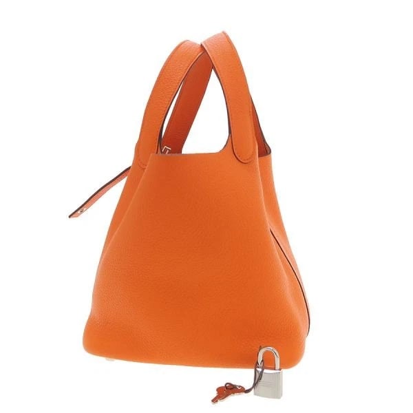 HERMES PICOTIN LOCK PM HANDBAG BUCKET BAG: Hermes Picotin Lock PM Handbag Bucket Bag Brand: Hermes Type/Style: Bag Material: Exterior Material Taurillon Clemence Leather Color: Exterior Color Orange Size: Width: 7.1inches (18cm) Height: 6.7inc