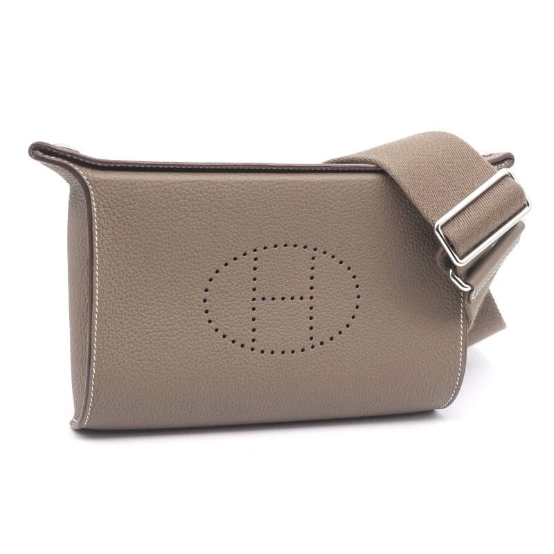 HERMES VIDE POCHE SHOULDER BAG: Hermes Vide Poche Shoulder Bag Brand: Hermes Type/Style: Bag Material: Exterior Material Togo Leather Color: Exterior Color Etoupe Size: Width: 8.3 inches (21 cm) Height: 5.5 inches (14 cm) Depth: 1.6