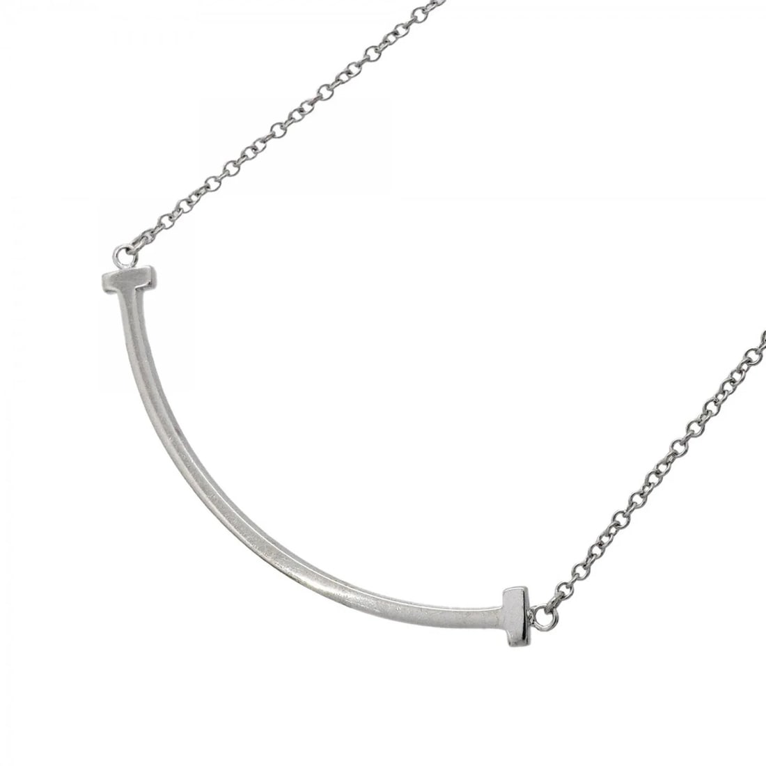 TIFFANY & CO. T SMILE SMALL NECKLACE: Tiffany & Co. T Smile Small Necklace Brand: Tiffany Type/Style: Necklace Material: White gold (18K) Color: White gold Size: Neck Circumference 40.5 cm - 45.5 cm / 15.94'' - 17.91'' Pendant Size 9.8mm
