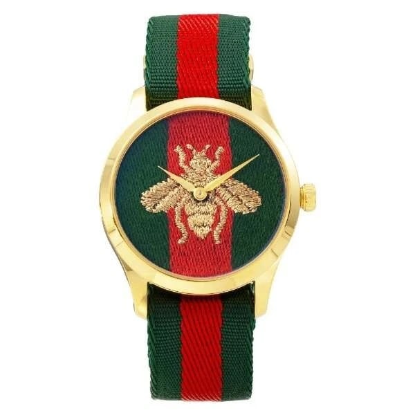 GUCCI G-TIMELESS GREEN WATCH: GUCCI G-Timeless Green Watch Brand: Gucci Type/Style: Wristwatch Material: Case Material Stainless steel (yellow gold PVD) Band material Nylon Color: Dial Color Green Size: [Case size] Height 38 x