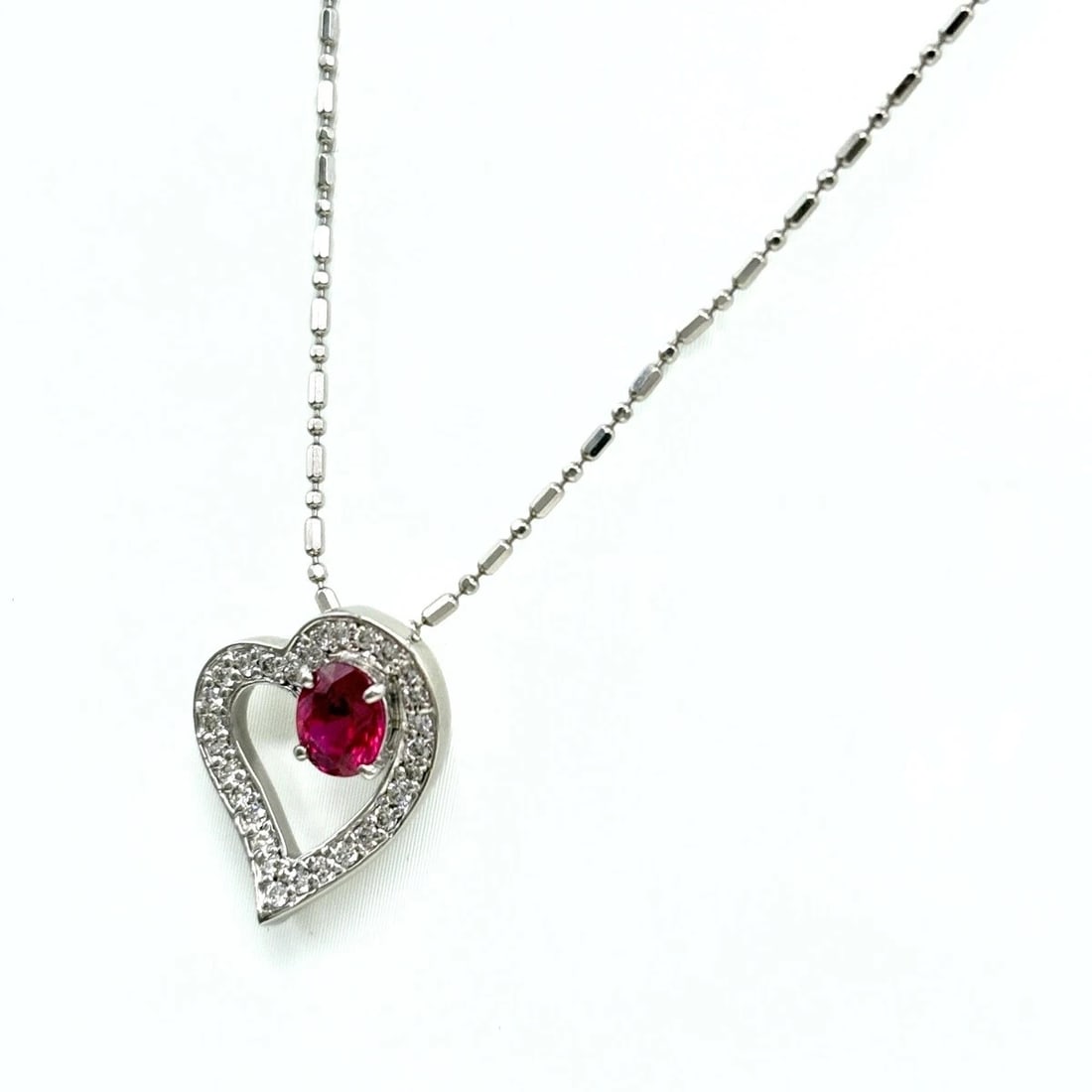 HEART MOTIF DESIGN NECKLACE PLATINUM PENDANT: Heart motif design Necklace Platinum Pendant Brand: Unbranded Type/Style: Necklace Material: Pt900, Main Stone Ruby Color: PT Size: Chain / code 45.5cm(17.9") Pendant size 15.6?12.8mm(0.6")