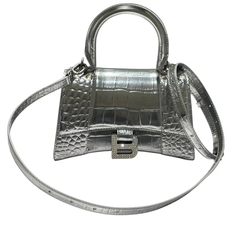 BALENCIAGA HOURGLASS SILVER RHINESTONE EMBOSSED LEATHER: Balenciaga Hourglass Silver Rhinestone Embossed Leather Brand: BALENCIAGA Type/Style: Handbag Material: Embossed Leather Color: Silver, rhinestones Size: W: 19cm / H: 13cm / D: 8cm Accessories: None