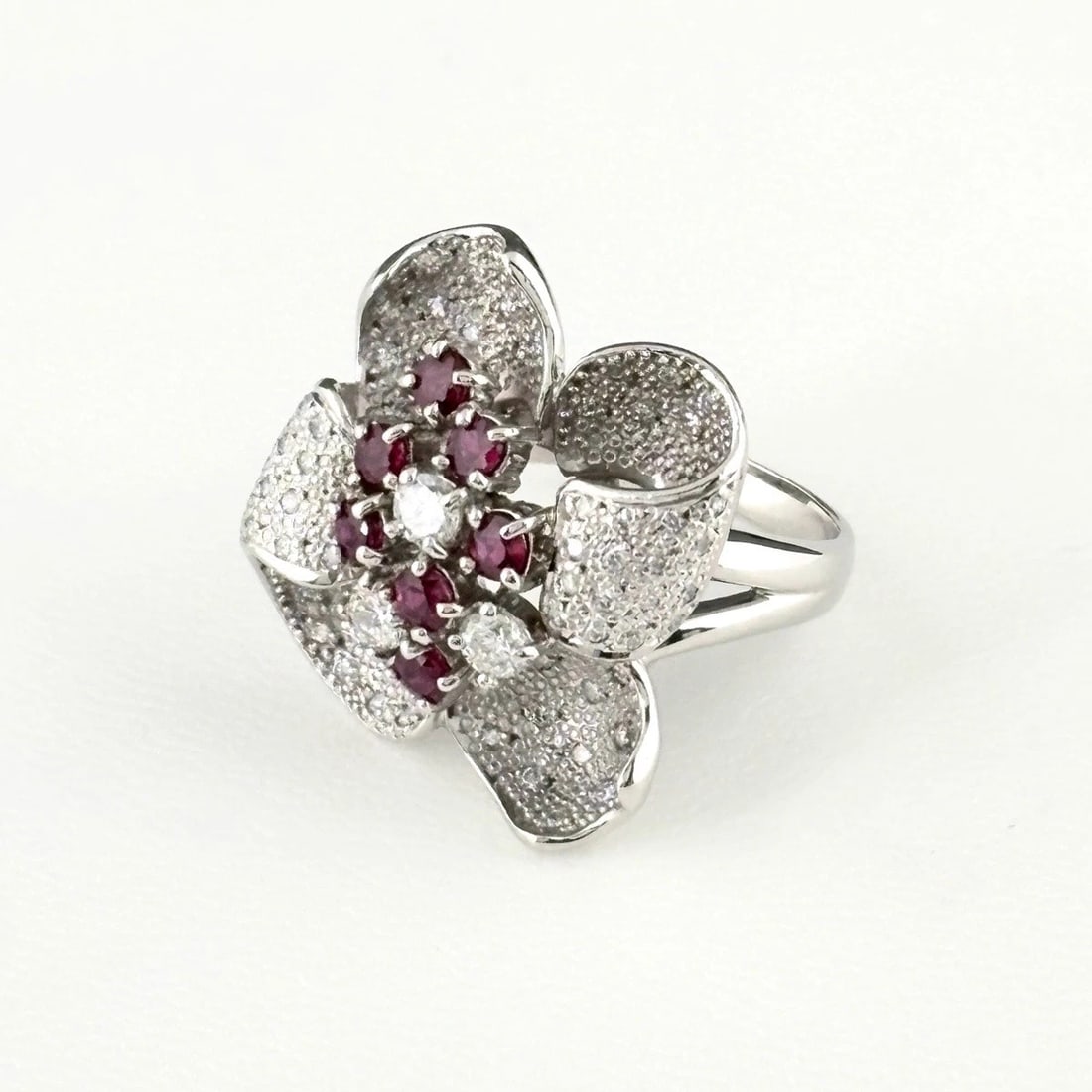 FLOWER MOTIF DESIGN RING: flower motif design ring Brand: Unbranded Type/Style: Ring Material: Pt900, Main Stone ruby Color: PT Size: US 7.5 to 8 Accessories: None Accessories Notice: When purchasing pre-owned good